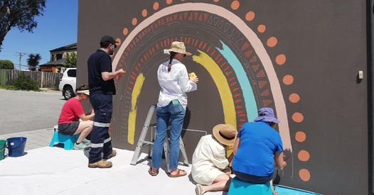 community mural installation in progress