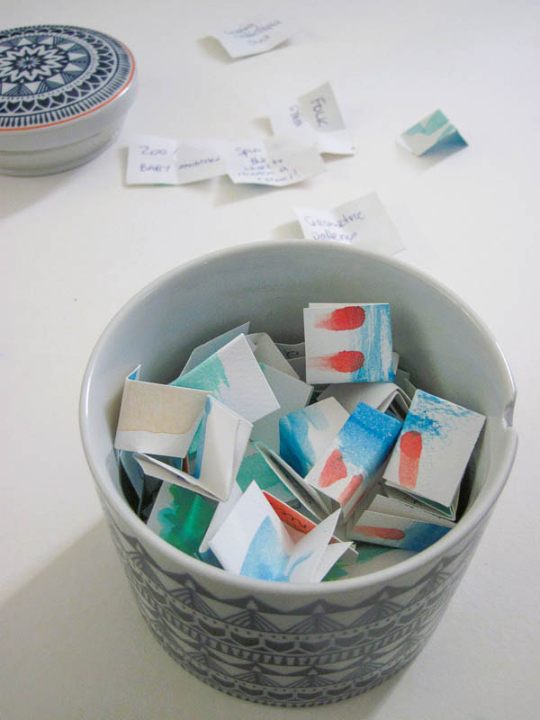ceramic jar filled with ideas on paper squares