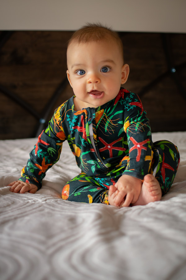 Baby in jumpsuit with a watercolour surface pattern